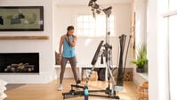Woman doing a standing biceps curl--thumbnail